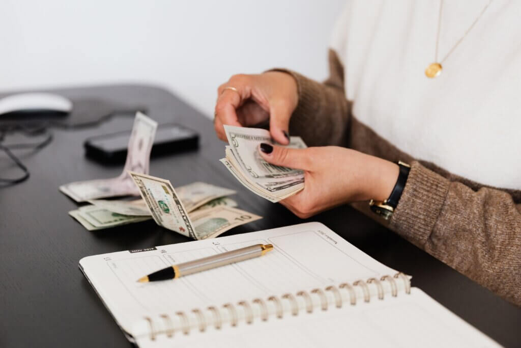 counting money for a budget with a notebook