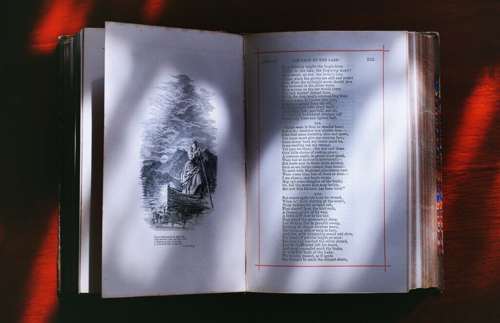 photograph of open book with illustration on left page and text on right page