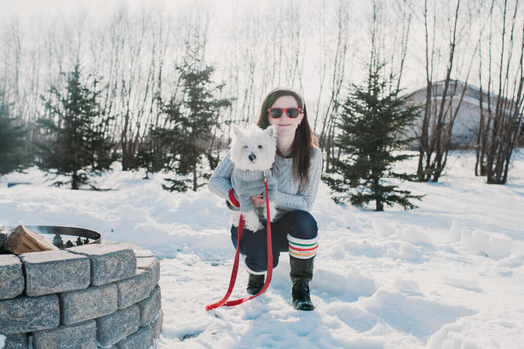 women and westie in grey sweaters